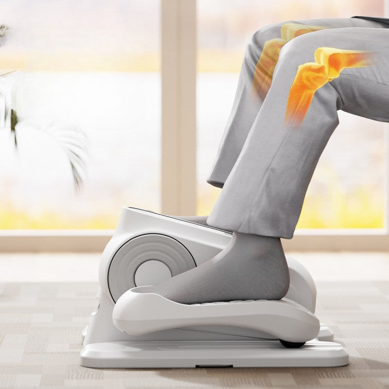 Person using a white foot exerciser on a light wooden floor.